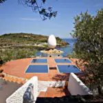 Back patio of Casa Salvador Dali with large egg statue overlooking the bay